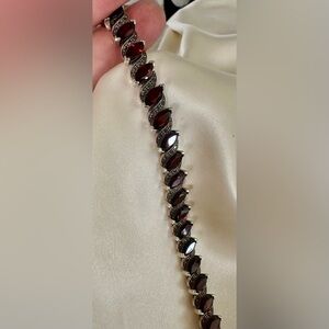 Vintage garnet and marcasite tennis bracelet with 29 garnet stones.